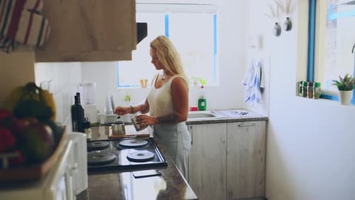 Woman Prepares Coffee in a Bright Kitchen