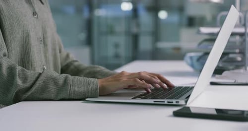 4k video footage of an unrecognisable businesswoman using a laptop in a modern office
