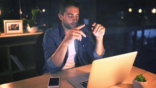 Businessman, glasses and tired at night with fatigue in office for work by rubbing eyes