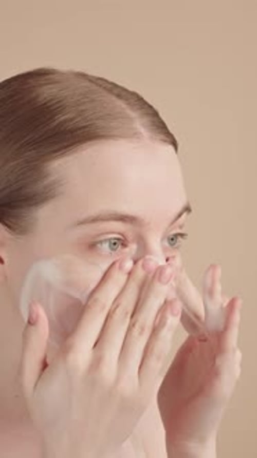 Young Woman Enjoying Her Skincare Routine Gently Applying Foaming Cleanser