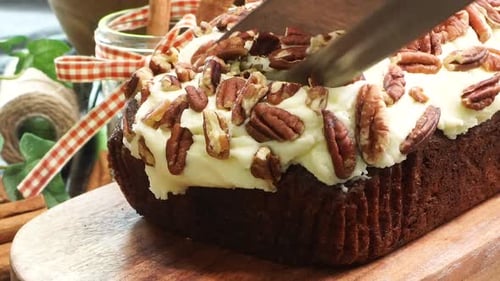 Slicing Into Pecan Frosted Loaf Cake