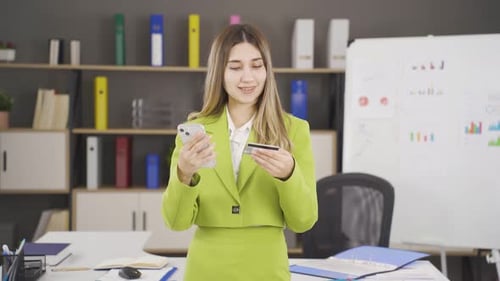 Woman Shopping Online With Credit Card at Office
