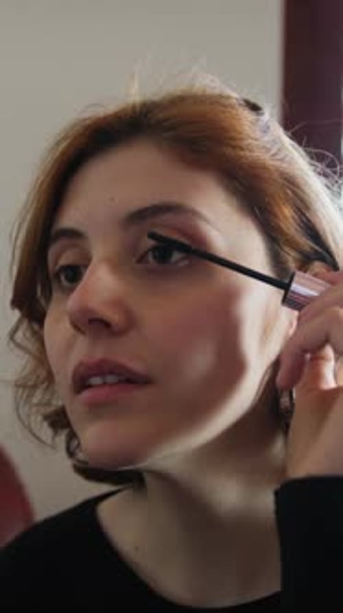 Young Woman Applying Mascara Close Up Portrait