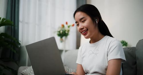 Young Woman Video Calling on Laptop From Home