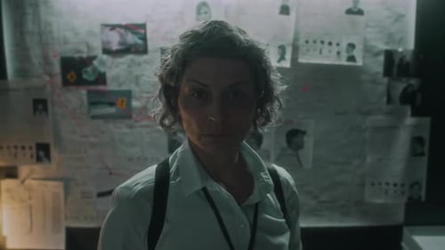 Woman Stands Before Investigation Evidence Board