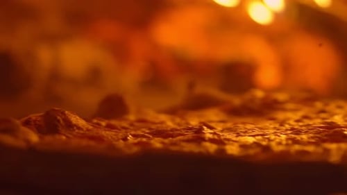 Closeup of Pepperoni Pizza Being Unwrapped By Pizza Maker in a Wood Stove Rotating of a Fresh Tasty