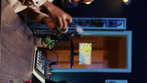 Young Adult Prepares Audio Mixing Desk