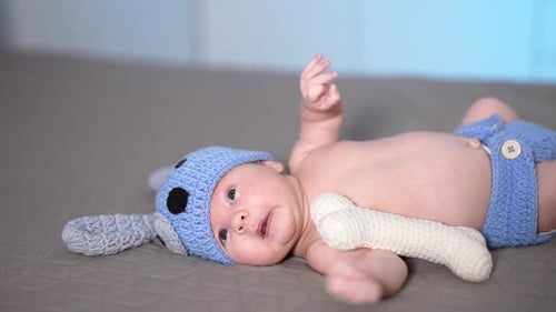 Charming Infant Lying Down Wearing a Dog Hat