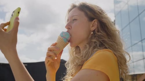 Woman Enjoys Ice Cream and Takes a Selfie