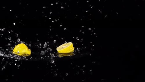 Lemon Splashing into Water on Black Background