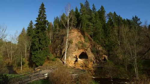 Landscape with a Cliff and a Cave Entrance, a River and a Viewing Area