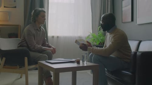 Therapist Talking With Man About Pills in Office