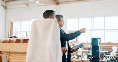 Carpenter, woodwork and apprentice with mentor in workshop, discussion and walking
