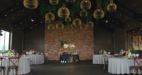 Rustic or Loftstyle Restaurant Decorated for a Festive Wedding Dinner