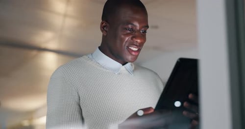 Night, office and business black man on tablet for internet, website research and browse online