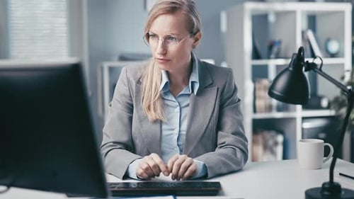 Woman Working at Computer in Bright Office