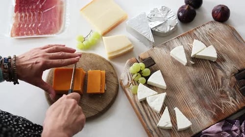 Fille découpant du fromage sur une planche pour planche à fromage