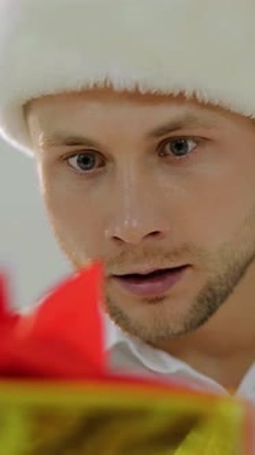 A Joyful Man in a Santa Hat Shares the Magic of Christmas Joy