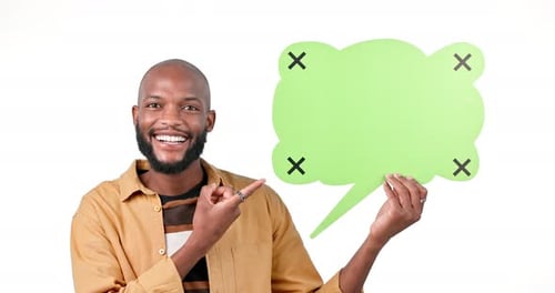 Happy black man, speech bubble and pointing to mockup in advertising against a studio background