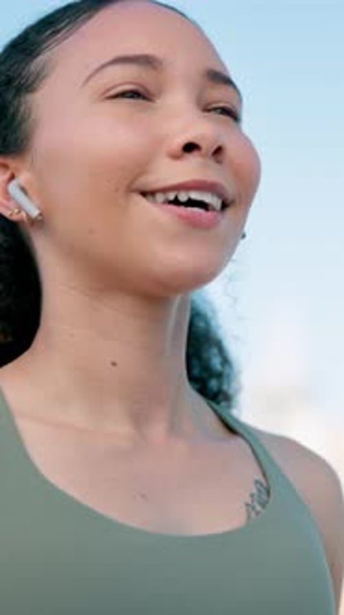 Runner, thinking and woman with earphones in city for exercise, workout and training with music