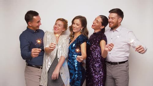 Friends Celebrate Together Holding Sparklers in Studio