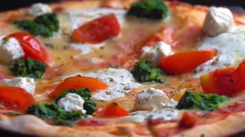 Top view of fresh baked pizza with tomatoes and cheese mozzarella rotate on tray