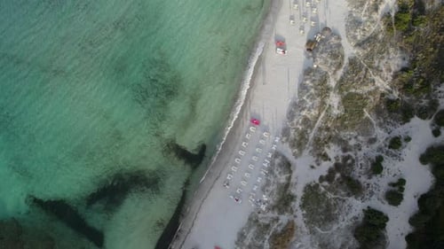 Aerial top-down shot of a beautiful sandy beach completely empty due to the coronavirus pandemic loc