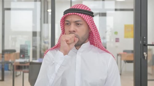 Man Coughing in Office Environment