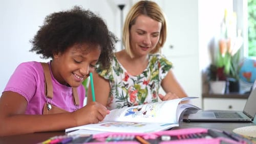 Girl Doing Homework with Helpful Woman at Table
