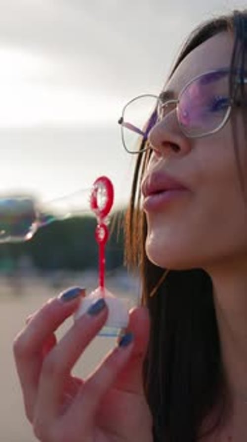 Portrait Happy Brunette Woman Wearing Glasses Blowing Soap Bubbles