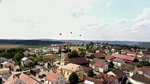 Aerial View of Town with Heart-Shaped Balloons
