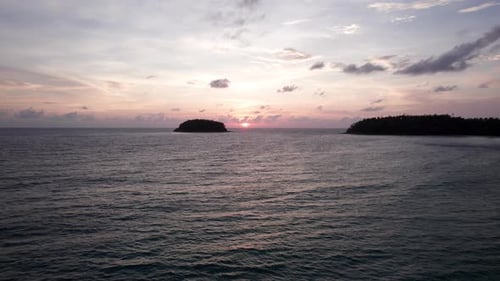 A Tropical Island at Sunset in the Middle of Ocean