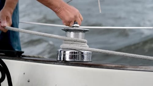 Close Up of Male Hands Pulling Rope of Sailboat Yachtsman Hands Dealing with Yacht Ropes on Halyard