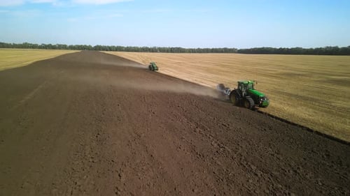 Tractors plowing the field in Ukraine