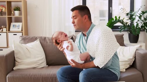 Family, Parenthood and Fatherhood Concept - Middle Aged Father Comforting Crying Little