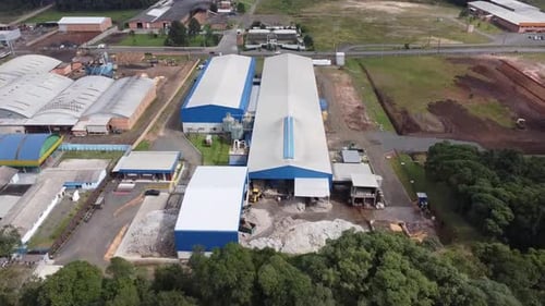 Approaching the industrial giant: drone footage flies towards the factory warehouse, showcasing its