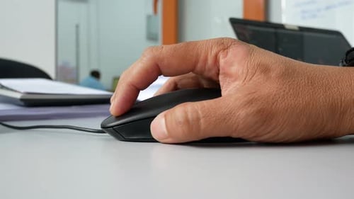 A man hand using black computer mouse