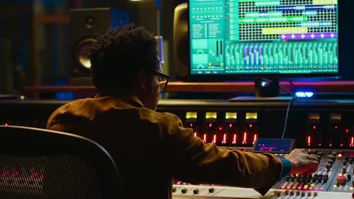 Sound Designer Uses Mixing Console and Managing Audio Tracks