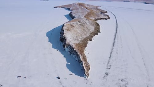 Drone Captures a Breathtaking Snowy Landscape Above a Frozen Region with Ice Crevices