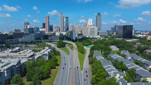 Traffic scene in Atlanta Downtown. Skyline with towers and skyscrapers in distance. Modern residenti