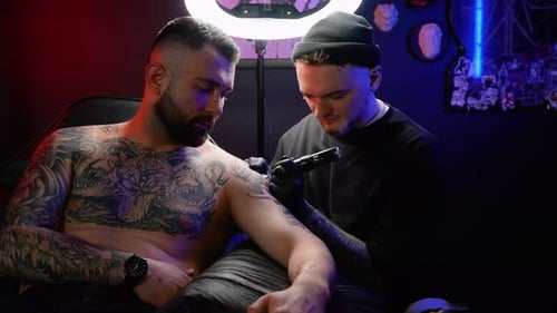 Professional Tattoo Artist Makes a Tattoo in the Studio