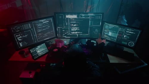 Hacker Coding at Multiple Monitors in Dark Room