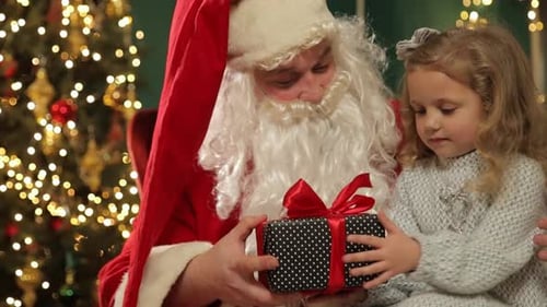 Santa Claus Giving Gift to Blond-haired Girl