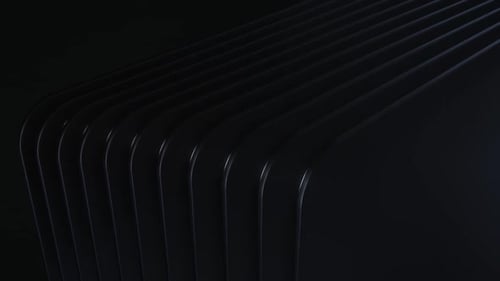 Glatte schwarze Paneele mit geschwungenen Kanten auf dunklem Hintergrund