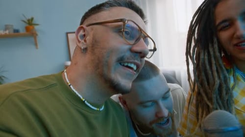 Friends singing karaoke together at home, close up