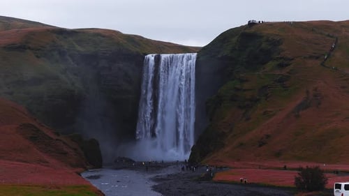 Skogafoss Waterfall Flowing Through Green Cliffs in Iceland