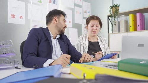 Office Workers Collaborate on Laptop Analysis