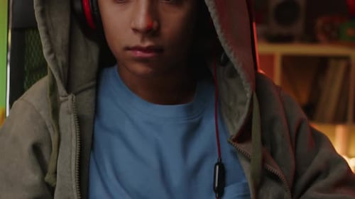 Teen Plays Video Games at Home