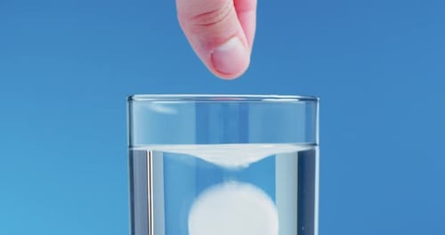 Effervescent Tablet Dissolves in Glass of Water