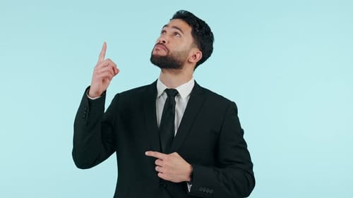 Face, business and man with option, pointing up or opportunity on blue studio background